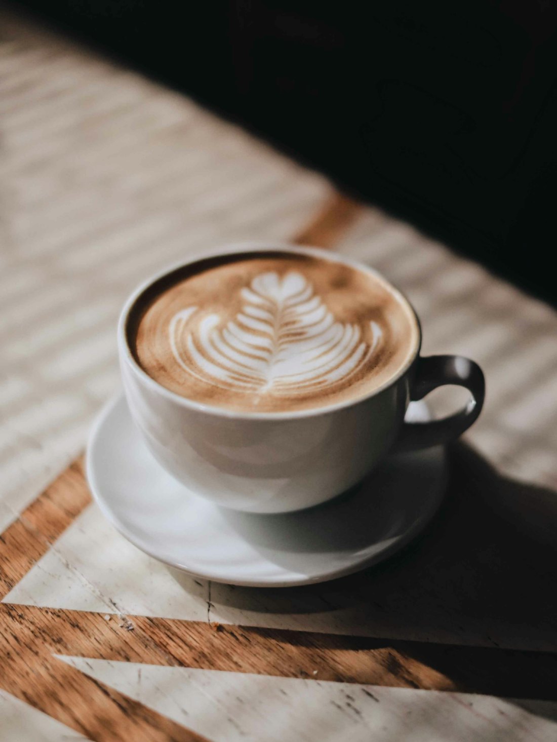Cappuccino with latte art in a white cup